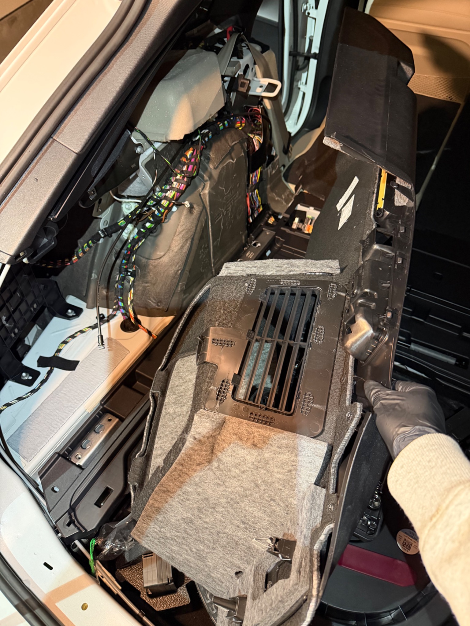 Side trim removed from the A6 Allroad trunk to expose wiring and modules