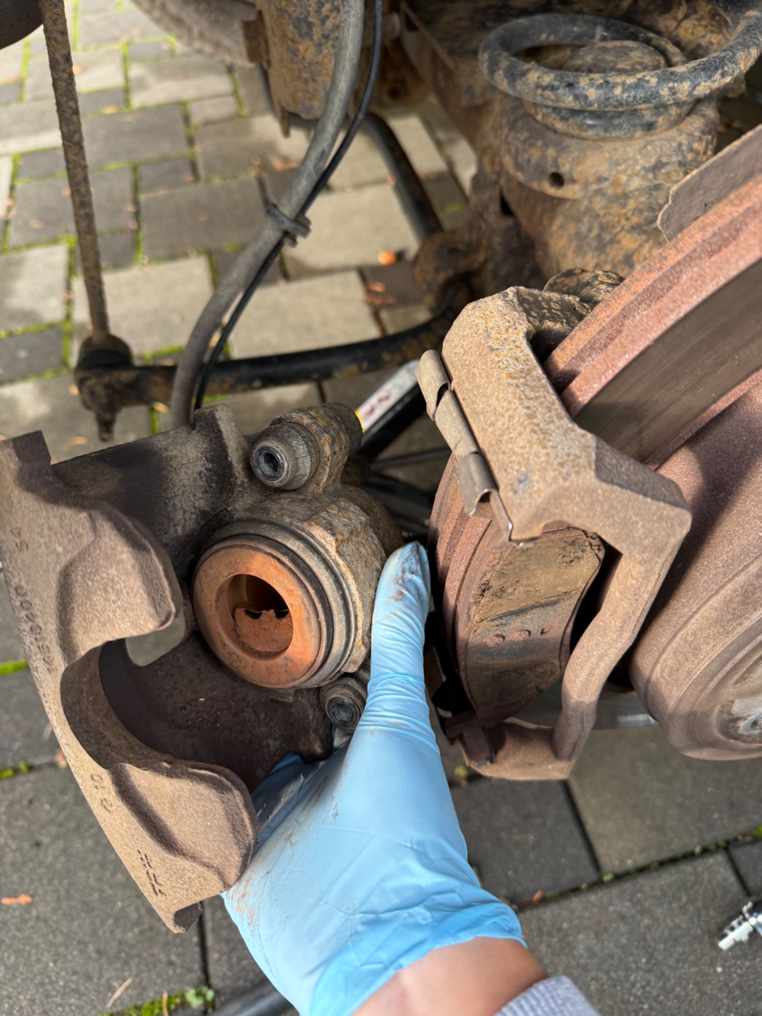Close view of the opened brake caliper during the pad replacement